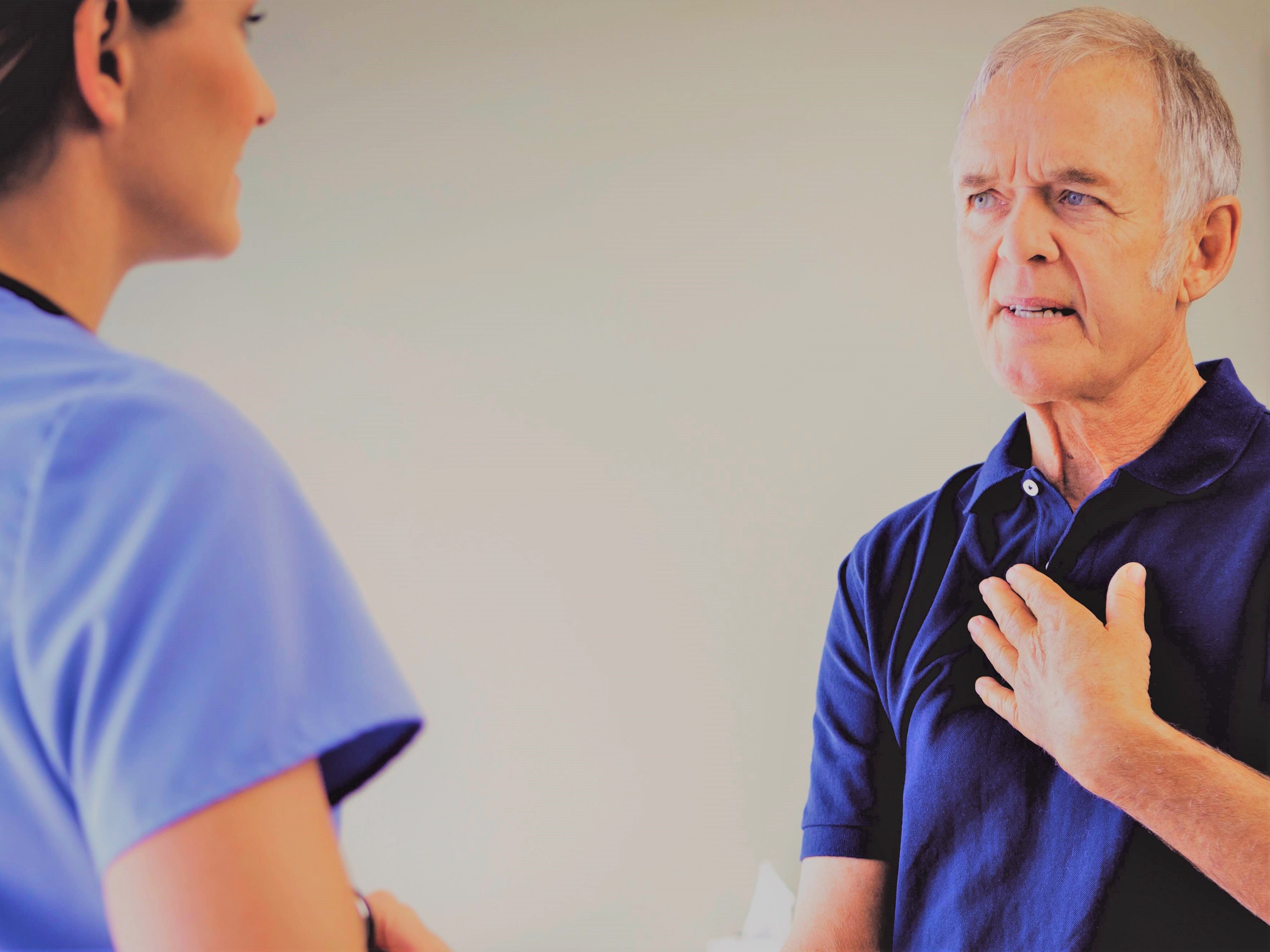 elderly-man-with-swallowing-difficulties-consulting-female-doctor