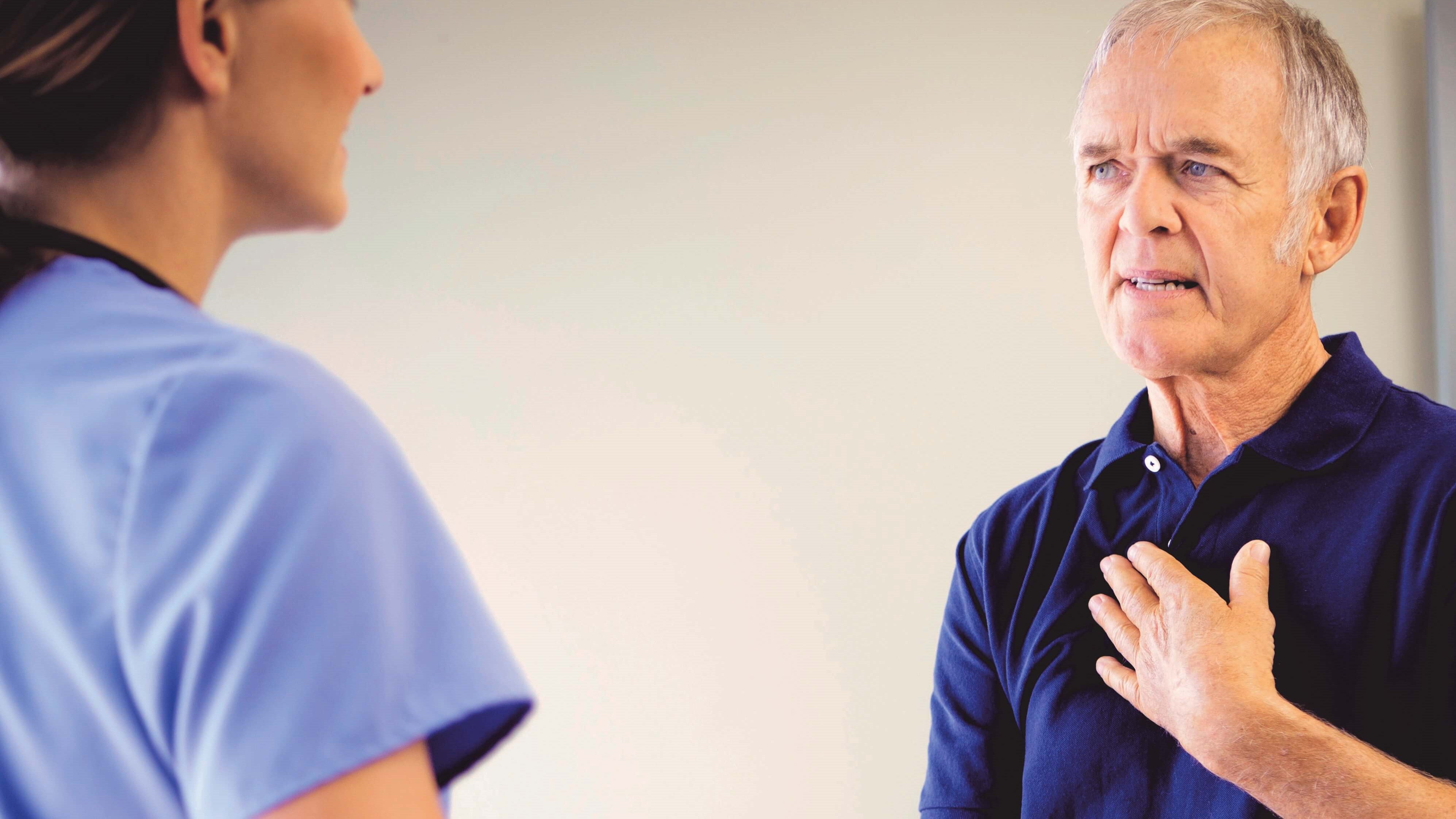 elderly-man-with-difficulty-swallowing-consulting-doctor